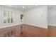 Sun-drenched bedroom with hardwood floors, large window, and direct access to a porch at 1310 Durlain Dr # 107, Raleigh, NC 27614