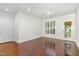 Bright bedroom with hardwood floors, crown molding, and two doors leading to outdoor spaces at 1310 Durlain Dr # 107, Raleigh, NC 27614