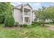 Inviting condo exterior showcasing a charming balcony, manicured landscaping, and lush greenery at 1310 Durlain Dr # 107, Raleigh, NC 27614