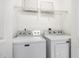 Laundry area with new front load washer and dryer with storage shelf above at 1310 Durlain Dr # 107, Raleigh, NC 27614