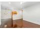 Open-concept living room with hardwood floors and modern fixtures, connecting to the kitchen at 1310 Durlain Dr # 107, Raleigh, NC 27614