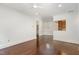 Bright living room with hardwood floors and modern lighting, flowing into dining area at 1310 Durlain Dr # 107, Raleigh, NC 27614