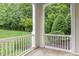 Covered porch and outdoor space overlooks the green grass and surrounding trees at 1310 Durlain Dr # 107, Raleigh, NC 27614