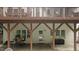 Spacious patio area underneath a deck, features outdoor furniture and access to the backyard, ideal for entertaining at 1332 Kinsdale Dr, Raleigh, NC 27615