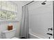 Bathroom with tile floors, subway tile, and bathtub with shower at 1332 Kinsdale Dr, Raleigh, NC 27615