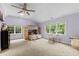 Bedroom with a bunk bed, carpet, three windows, and a ceiling fan at 1332 Kinsdale Dr, Raleigh, NC 27615