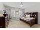 This bedroom features carpet floors, a ceiling fan, two windows, and a bed at 1332 Kinsdale Dr, Raleigh, NC 27615