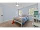 This is a bedroom with carpet floors, a fan, and a view of two windows at 1332 Kinsdale Dr, Raleigh, NC 27615