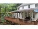 Spacious outdoor deck featuring a seating area, covered awning, and beautiful backyard views, perfect for relaxing and entertaining at 1332 Kinsdale Dr, Raleigh, NC 27615