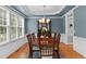 Formal dining room featuring blue walls, white trim, and a traditional chandelier at 1332 Kinsdale Dr, Raleigh, NC 27615