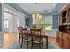 Elegant dining room with blue accent walls, detailed molding, and wood flooring at 1332 Kinsdale Dr, Raleigh, NC 27615