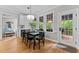 Dining area with backyard view and features a wine rack, wood floors and white cabinetry at 1332 Kinsdale Dr, Raleigh, NC 27615