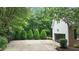 Long driveway to a house with a brick accent and a basketball hoop, and a garage at 1332 Kinsdale Dr, Raleigh, NC 27615