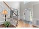 Bright foyer with hardwood floors, staircase, and arched transom window above front door at 1332 Kinsdale Dr, Raleigh, NC 27615