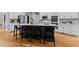 Modern kitchen featuring a large island with seating and stainless steel appliances at 1332 Kinsdale Dr, Raleigh, NC 27615