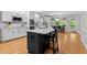 Open-concept kitchen with a large island, bar seating, and stainless steel appliances at 1332 Kinsdale Dr, Raleigh, NC 27615