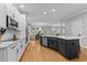 Spacious kitchen with a center island, modern appliances, and hardwood flooring at 1332 Kinsdale Dr, Raleigh, NC 27615