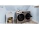 Well-lit laundry room featuring a utility sink and side-by-side washer and dryer machines at 1332 Kinsdale Dr, Raleigh, NC 27615