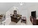 Relaxing living room space with a comfy couch, entertainment center, and a ceiling fan for added comfort at 1332 Kinsdale Dr, Raleigh, NC 27615
