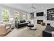 Bright living room features a cozy fireplace, built-in shelves, and plush seating at 1332 Kinsdale Dr, Raleigh, NC 27615