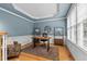 Cozy home office featuring built-in shelving and a comfortable seating area at 1332 Kinsdale Dr, Raleigh, NC 27615