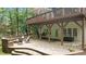Beautiful stone patio featuring comfortable seating, a fire pit, and access to the home's lower level, perfect for outdoor gatherings at 1332 Kinsdale Dr, Raleigh, NC 27615