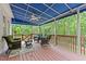 Charming covered porch featuring comfortable seating, ceiling fan, and serene views of the surrounding greenery at 1332 Kinsdale Dr, Raleigh, NC 27615