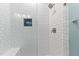This tiled shower features white subway tile, glass door, and a built in shower niche at 1332 Kinsdale Dr, Raleigh, NC 27615