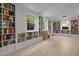 Large basement living area with built-in bookshelves and bright windows at 1706 Rangecrest Rd, Raleigh, NC 27612
