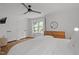 Cozy bedroom with natural light, hardwood floors, ceiling fan and neutral decor at 1706 Rangecrest Rd, Raleigh, NC 27612