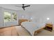 Bright bedroom with large window, hardwood floors, and modern furnishings at 1706 Rangecrest Rd, Raleigh, NC 27612