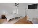 Clean bedroom with wood floors, natural light, and a ceiling fan at 1706 Rangecrest Rd, Raleigh, NC 27612