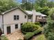 Expansive view of the home's exterior with a wooden deck, patio, and manicured landscaping at 1706 Rangecrest Rd, Raleigh, NC 27612
