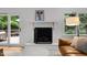 Charming living room with a fireplace and a view to a backyard deck at 1706 Rangecrest Rd, Raleigh, NC 27612