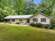 Charming one-story home features a well-manicured lawn and lush landscaping at 1706 Rangecrest Rd, Raleigh, NC 27612