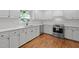 Well-lit kitchen with stainless appliances, white subway tile, and white cabinets at 1706 Rangecrest Rd, Raleigh, NC 27612