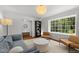 Bright living room featuring a large window and sophisticated decor at 1706 Rangecrest Rd, Raleigh, NC 27612