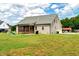 Expansive backyard showcasing a wooden deck, verdant lawn, and plenty of space for outdoor activities at 1779 Walter Grissom Rd, Kittrell, NC 27544