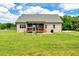 View of the house's backyard featuring a lawn, patio and playset at 1779 Walter Grissom Rd, Kittrell, NC 27544