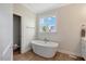 Stylish bathroom with a soaking tub and window at 1779 Walter Grissom Rd, Kittrell, NC 27544
