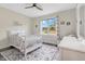 Cozy bedroom features a floral rug, a white bed, and a bright window view at 1779 Walter Grissom Rd, Kittrell, NC 27544