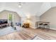 Sun-filled bedroom featuring hardwood floors, a ceiling fan, and large windows with scenic backyard views at 1779 Walter Grissom Rd, Kittrell, NC 27544