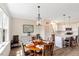 Charming dining area with a round table, decorative lighting, and adjacent kitchen at 1779 Walter Grissom Rd, Kittrell, NC 27544