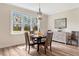 Sunlit dining area featuring a table set for a meal and scenic outdoor views at 1779 Walter Grissom Rd, Kittrell, NC 27544