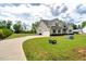 Charming two-story home with lush green lawn, mature landscaping, and attached two-car garage at 1779 Walter Grissom Rd, Kittrell, NC 27544