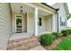 Covered front porch with brick steps and stylish entrance at 1779 Walter Grissom Rd, Kittrell, NC 27544