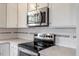 Well-equipped kitchen with stainless steel appliances and stylish backsplash details at 1779 Walter Grissom Rd, Kittrell, NC 27544