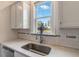 Close-up of a kitchen sink area with a window view and elegant fixtures at 1779 Walter Grissom Rd, Kittrell, NC 27544