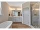 Elegant bathroom featuring double vanities, soaking tub, and a separate glass shower at 1779 Walter Grissom Rd, Kittrell, NC 27544