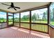 Relaxing screened-in porch with ample seating, ceiling fan, and beautiful views of the well-manicured yard at 1779 Walter Grissom Rd, Kittrell, NC 27544